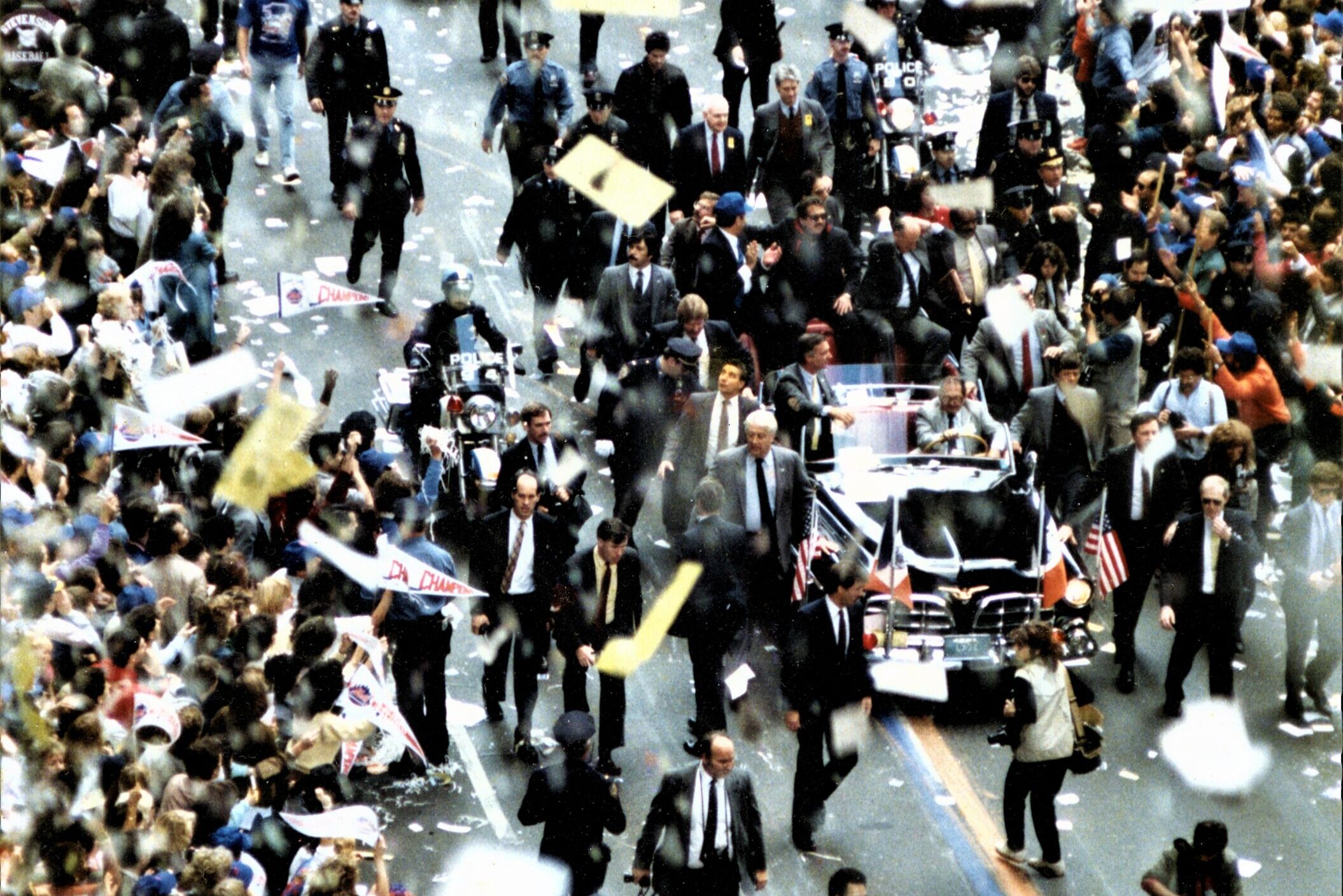 Exciting parade in New York City with dense crowds and festive confetti.